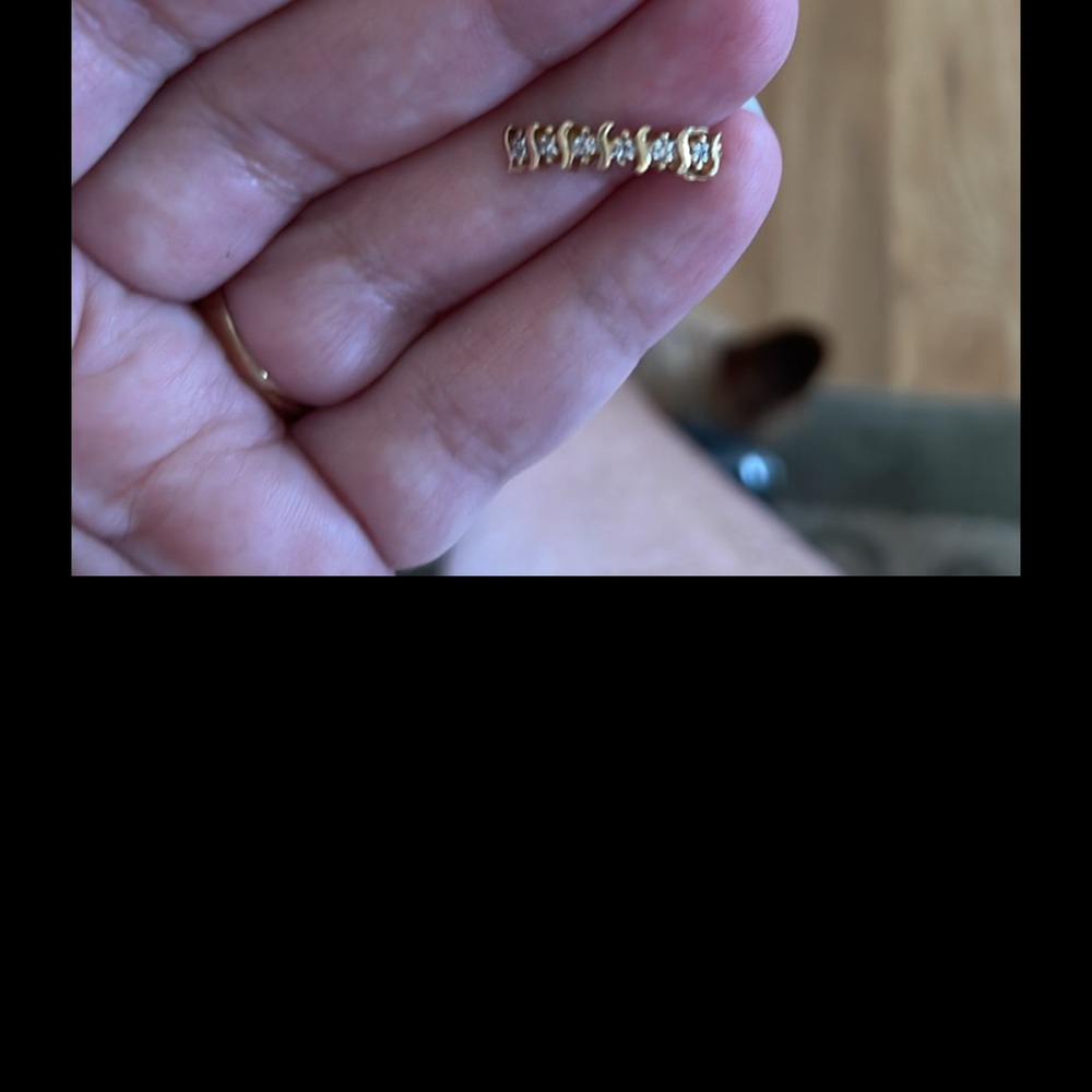 10kt yellow gold earrings with diamond accents. These earrings are on a curve.